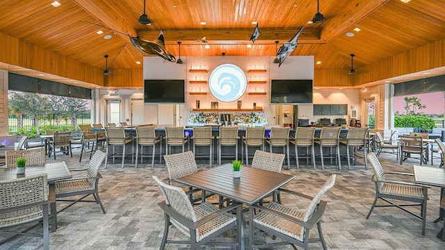 dining space featuring beamed ceiling, high vaulted ceiling, and wood ceiling