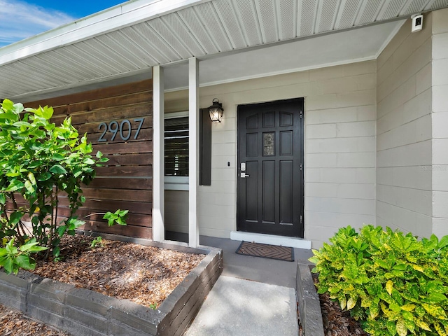 view of exterior entry with covered porch