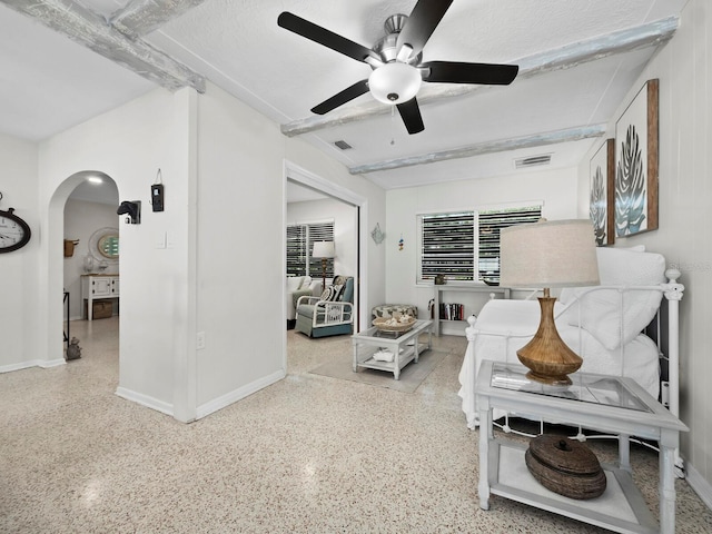 living room featuring a textured ceiling and ceiling fan