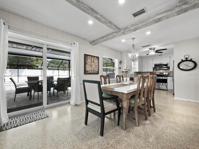 dining room with ceiling fan with notable chandelier and beamed ceiling