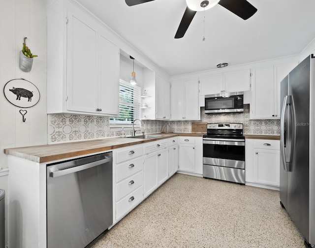 kitchen with appliances with stainless steel finishes, sink, white cabinetry, and ceiling fan