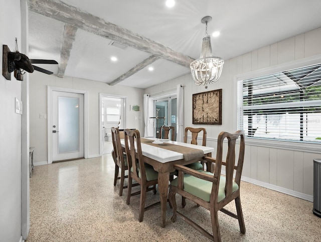 dining space featuring ceiling fan with notable chandelier and beamed ceiling