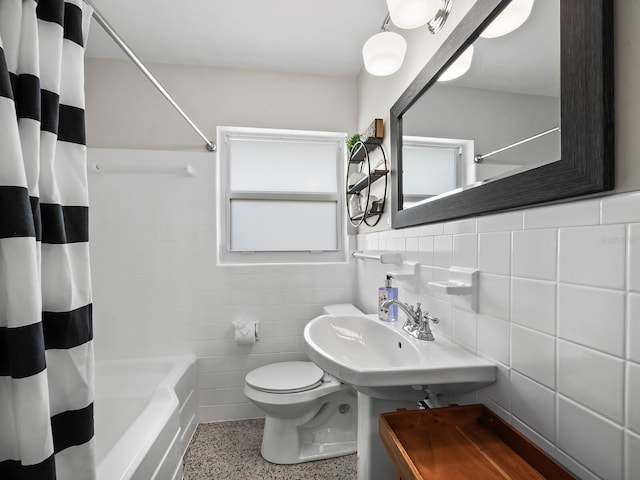 full bathroom with toilet, sink, decorative backsplash, tile walls, and shower / tub combo with curtain