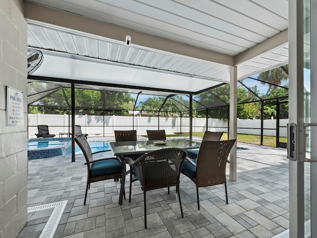 view of patio / terrace with a fenced in pool and glass enclosure