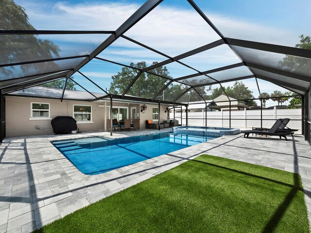 view of pool featuring glass enclosure and a patio