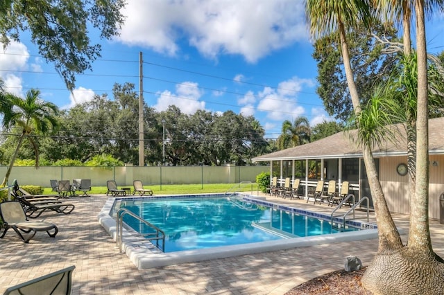 community pool featuring a patio area and fence