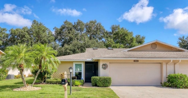 ranch-style house featuring a shingled roof, concrete driveway, a front yard, stucco siding, and an attached garage