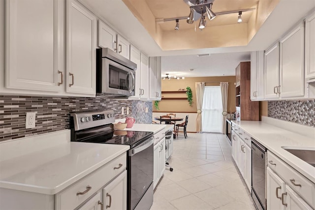 3541 Wilkinson Woods Dr Unit 40, Sarasota, FL 34231 - kitchen with appliances with stainless steel finishes, white cabinets, and light countertops