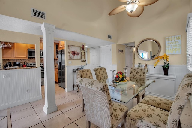 dining area with ornate columns, ceiling fan, and light tile patterned flooring