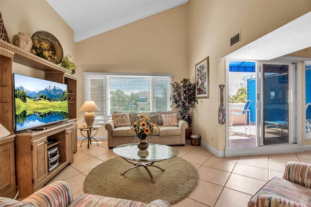 tiled living room with high vaulted ceiling