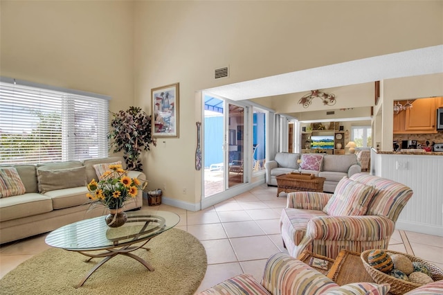 living room with a wealth of natural light and light tile patterned floors