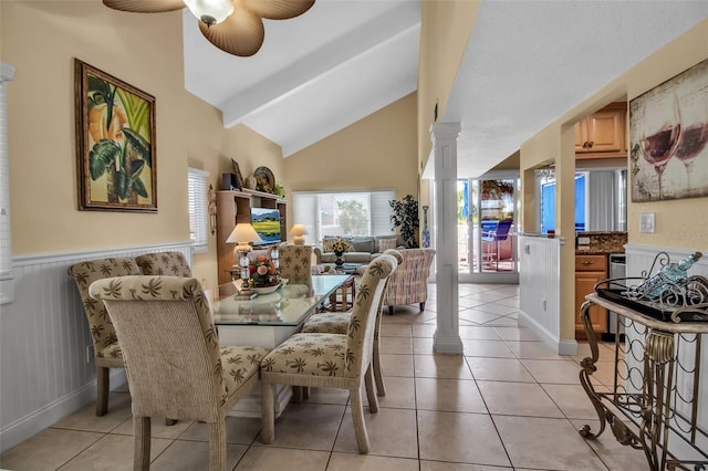 dining space featuring decorative columns, lofted ceiling, light tile patterned flooring, and ceiling fan