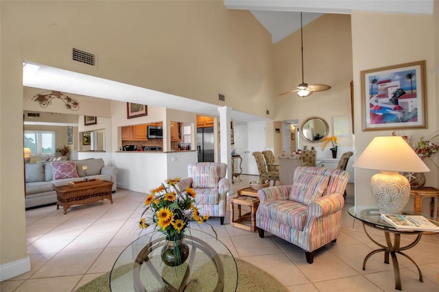 tiled living room with high vaulted ceiling and ceiling fan