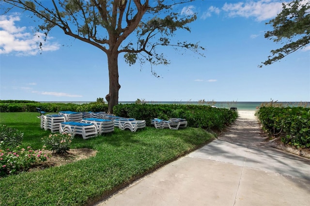 exterior space with a water view and a lawn