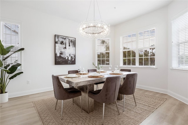 dining space with a notable chandelier and light wood-type flooring