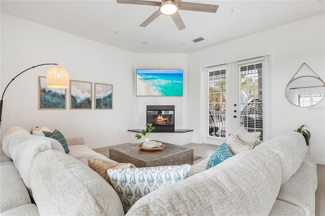 living room with light hardwood / wood-style flooring and ceiling fan