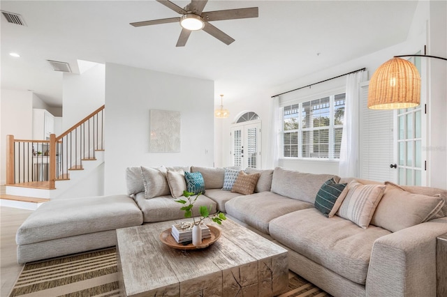 living room featuring light wood-type flooring and ceiling fan