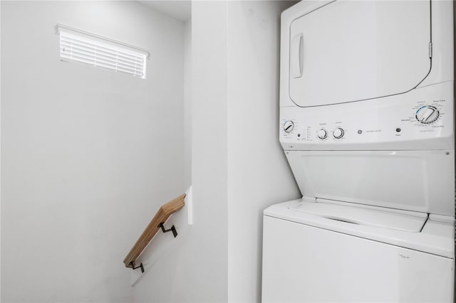 clothes washing area with stacked washer and dryer