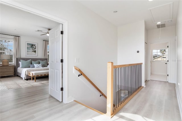 hall with plenty of natural light and light wood-type flooring