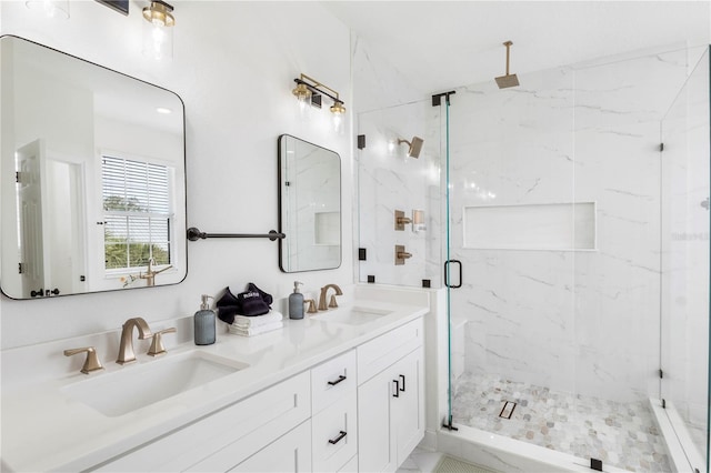 bathroom featuring a shower with door and vanity