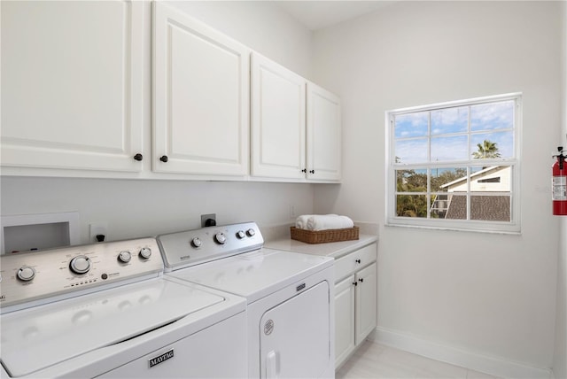 washroom featuring washer and dryer and cabinets