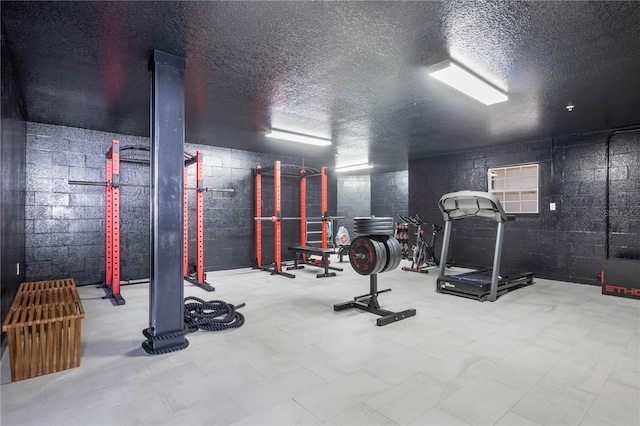 workout room featuring a textured ceiling