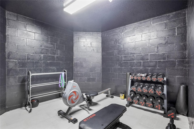 workout room featuring a textured ceiling