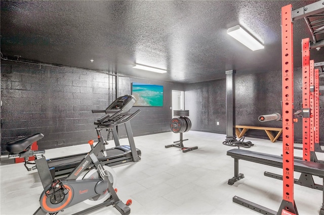 workout room with a textured ceiling