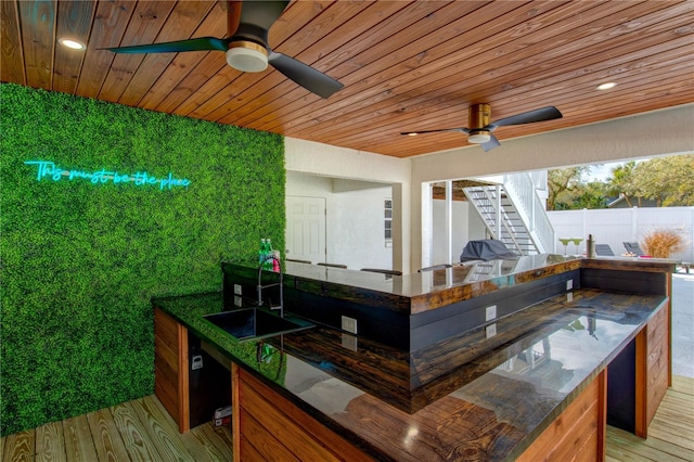 wooden deck featuring ceiling fan and sink