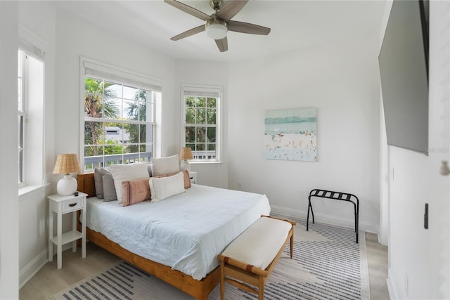 bedroom with multiple windows and ceiling fan