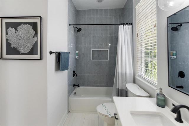 full bathroom with tile patterned floors, shower / bath combo, toilet, and vanity