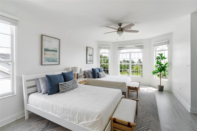 bedroom with ceiling fan and light wood-type flooring