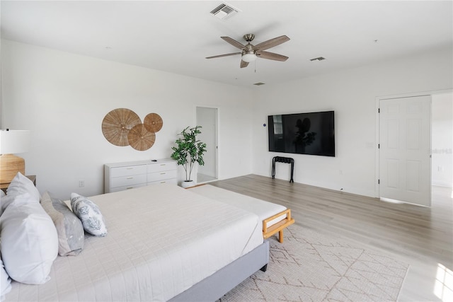 bedroom with ceiling fan and light hardwood / wood-style floors