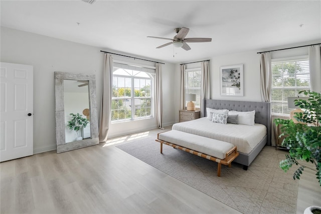 bedroom with light hardwood / wood-style flooring and ceiling fan