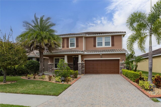 view of front of property featuring a front yard and a garage