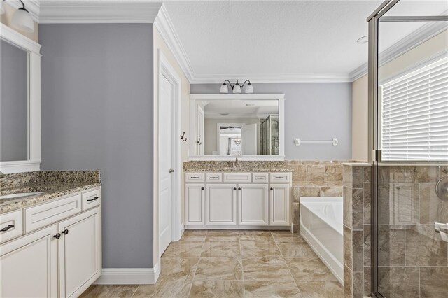 bathroom with a textured ceiling, ornamental molding, vanity, and separate shower and tub