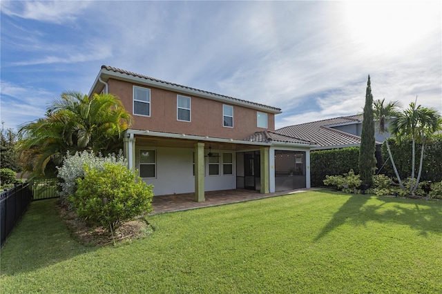 back of house featuring a lawn and a patio