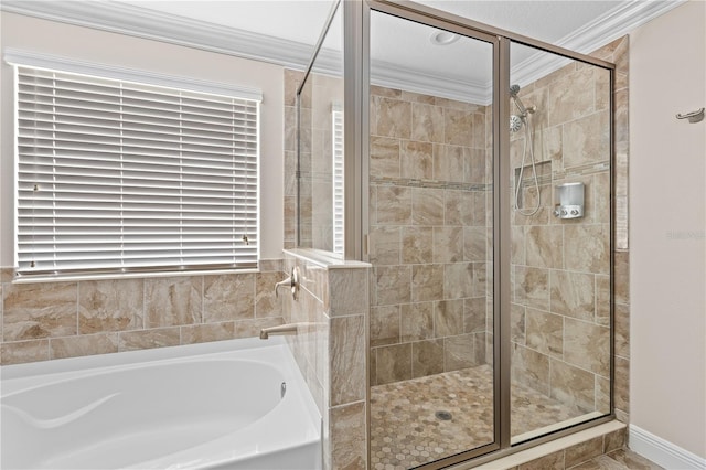 bathroom featuring ornamental molding and separate shower and tub