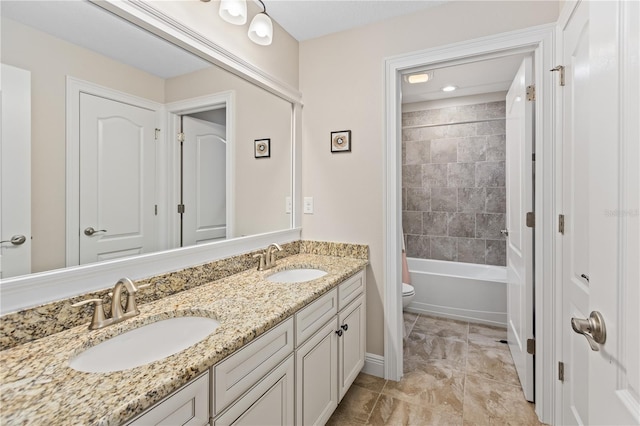 full bathroom with tiled shower / bath combo, vanity, and toilet