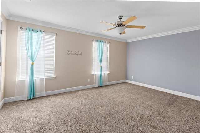 carpeted empty room featuring a healthy amount of sunlight, crown molding, and ceiling fan