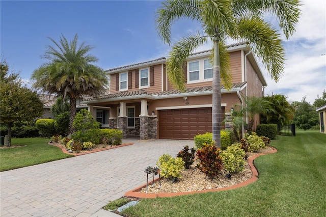 view of front facade featuring a front yard and a garage