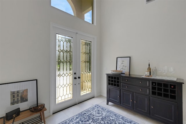 entrance foyer with french doors and light tile patterned flooring