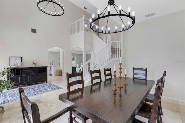 dining area featuring a high ceiling and an inviting chandelier