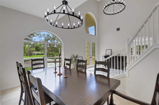 dining room featuring french doors and a chandelier