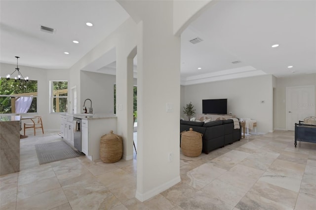 living room featuring an inviting chandelier and sink