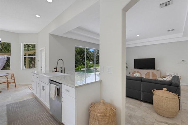 kitchen with dishwasher, light stone counters, white cabinetry, sink, and light tile patterned flooring