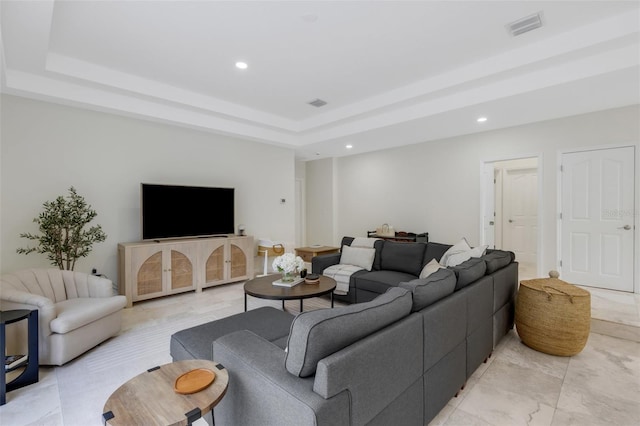 living room with a tray ceiling