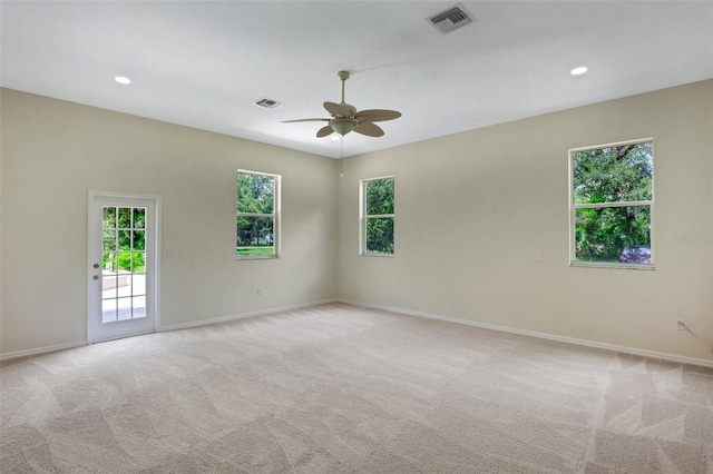 unfurnished room with ceiling fan and light colored carpet