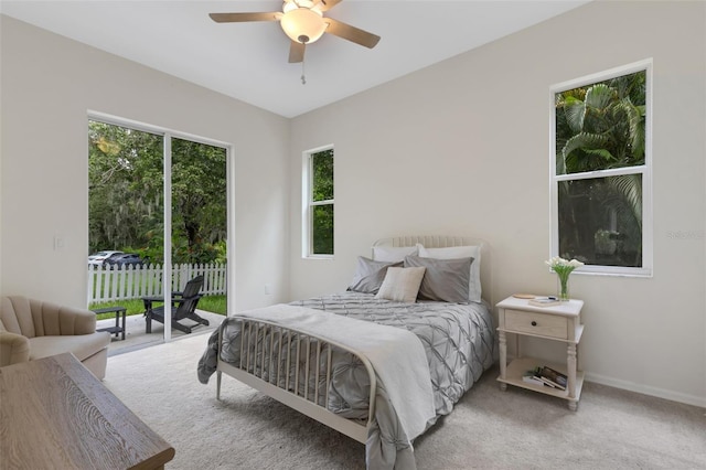 carpeted bedroom with ceiling fan, multiple windows, and access to outside