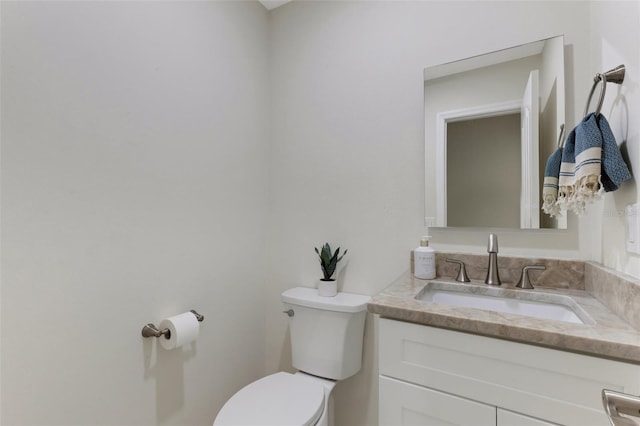 bathroom featuring toilet and vanity